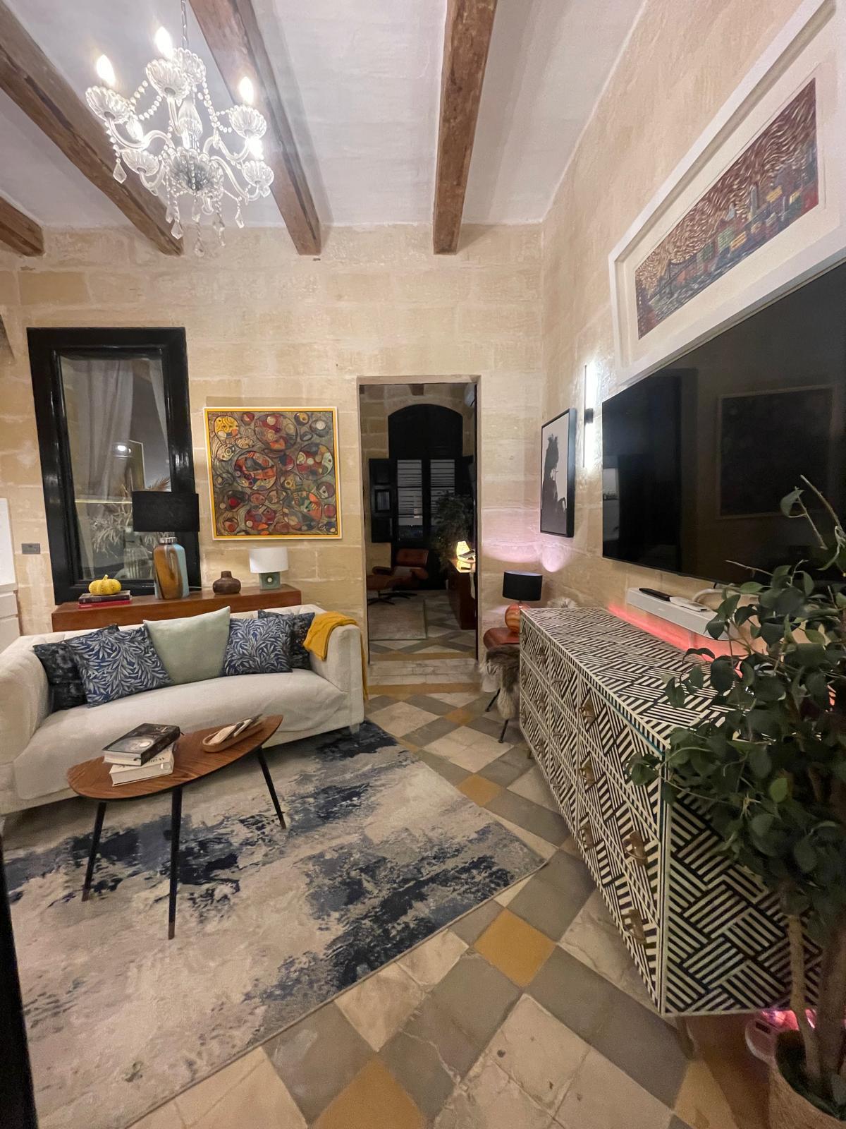 Lounge in the evening with sofa, painting and beams